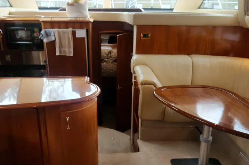  Yacht Photos Pics Luxurious interior of 2005 Carver 466 Motor Yacht with wood finishes and leather seating.
