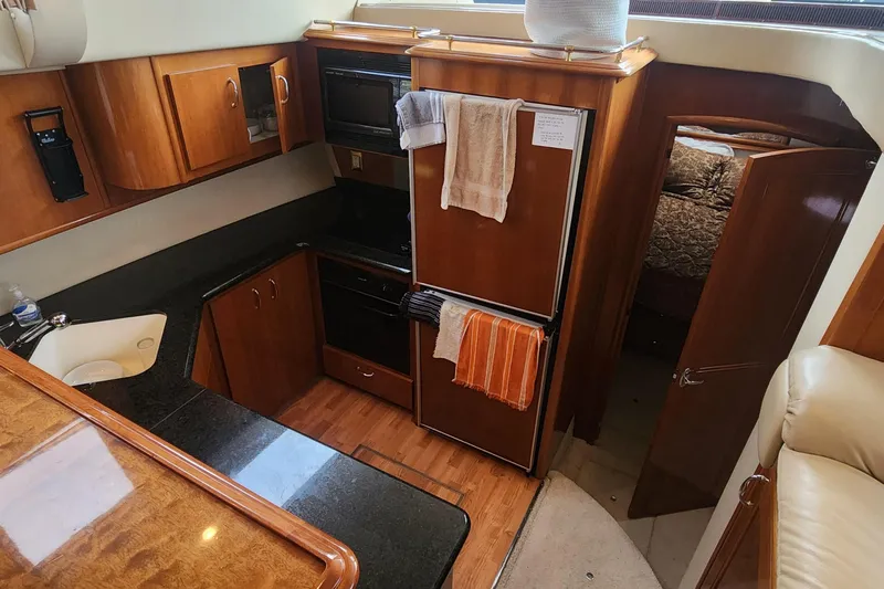  Yacht Photos Pics 2005 Carver 466 Motor Yacht kitchen with wood cabinetry and modern appliances.