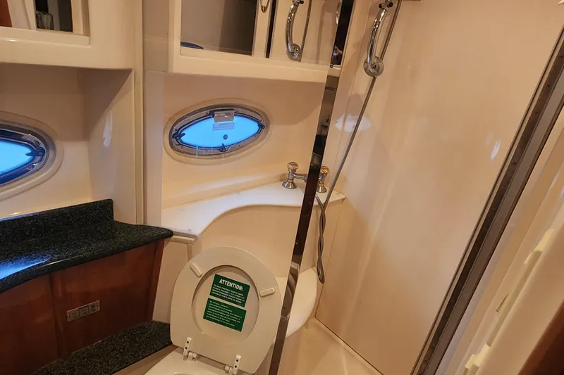  Yacht Photos Pics Bathroom interior of 2005 Carver 466 Motor Yacht with shower and porthole window.