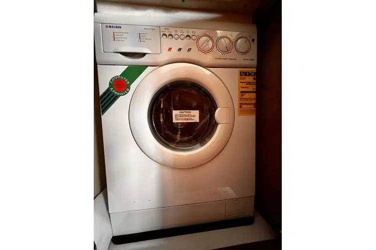  Yacht Photos Pics Front-loading washing machine inside 2005 Carver 466 Motor Yacht laundry area.