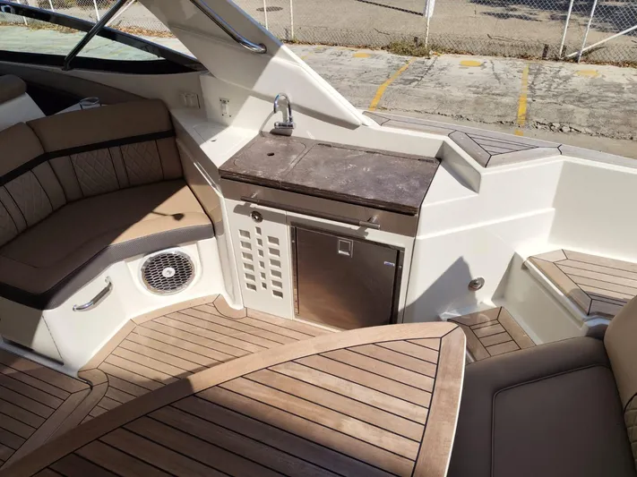 2018 Sea Ray 350 Slx @ Acapulco Yacht Photos Pics 2018 Sea Ray SLX 350 boat interior with seating, kitchenette, and wood flooring.