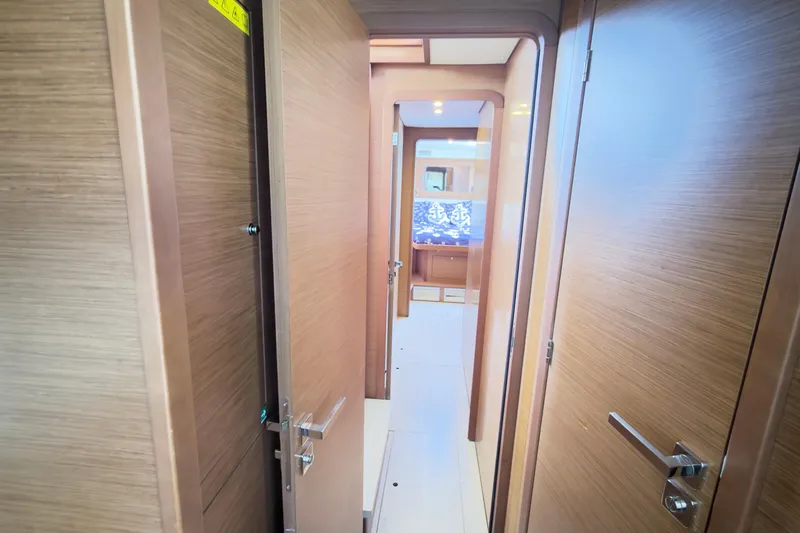 Carpediem 2 Yacht Photos Pics Interior hallway of 2019 Lagoon 450 catamaran with wooden doors and modern design.