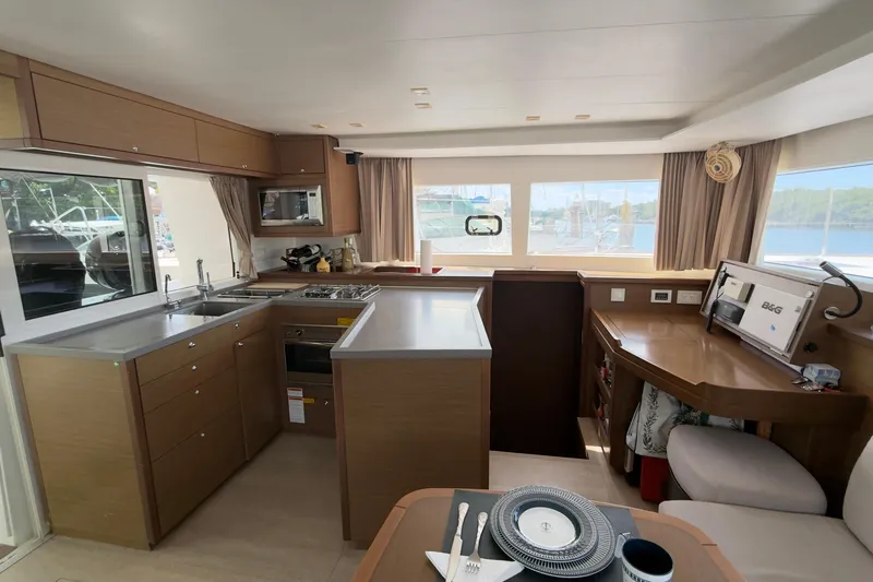 Carpediem 2 Yacht Photos Pics Luxurious interior of 2019 Lagoon 450 catamaran with modern kitchen and dining area.