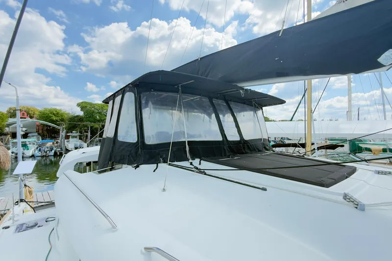 Carpediem 2 Yacht Photos Pics 2019 Lagoon 450 catamaran docked, featuring a covered cockpit and clear skies.