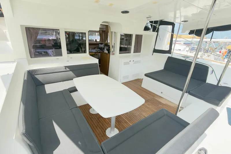 Carpediem 2 Yacht Photos Pics 2019 Lagoon 450 catamaran interior with seating area and table, featuring modern design.