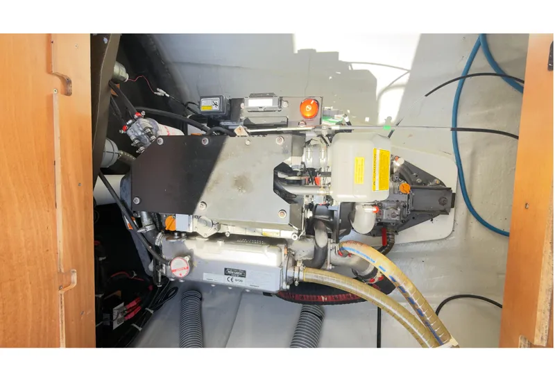 Carpediem 2 Yacht Photos Pics Engine compartment of a 2019 Lagoon 450 catamaran, showcasing mechanical components and wiring.