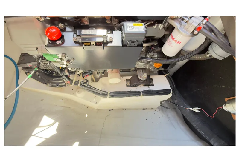 Carpediem 2 Yacht Photos Pics Engine compartment of a 2019 Lagoon 450 catamaran, showcasing mechanical components and wiring.