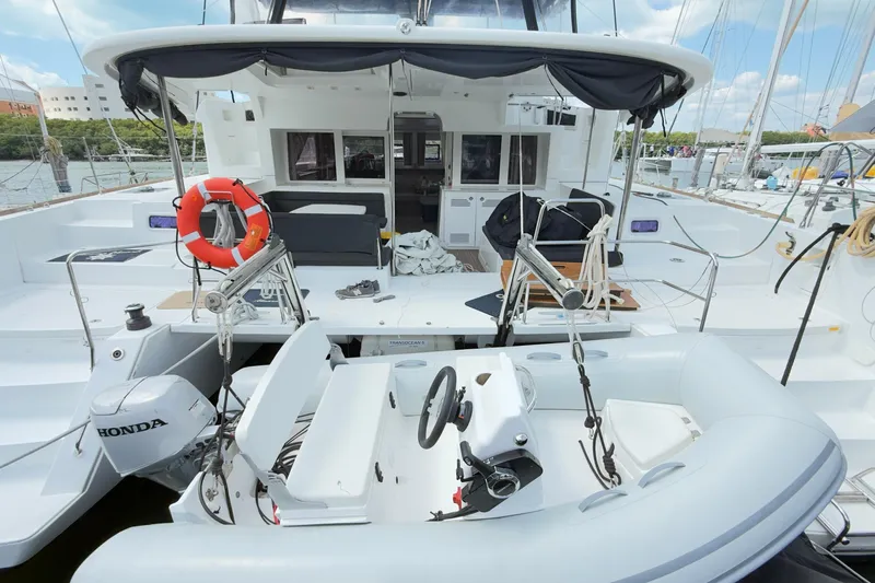 Carpediem 2 Yacht Photos Pics 2019 Lagoon 450 catamaran with Honda motor, docked at marina, featuring spacious deck and seating.