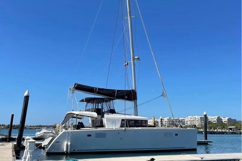 Carpediem 2 Yacht Photos Pics 2019 Lagoon 450 catamaran docked at marina under clear blue sky.