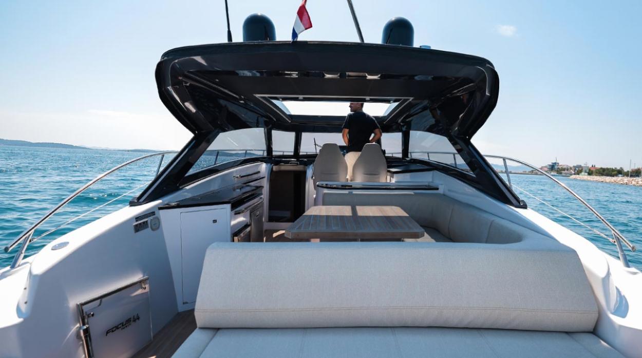 Luxurious 2026 Focus Power 44 yacht interior with seating, ocean view, and modern design.