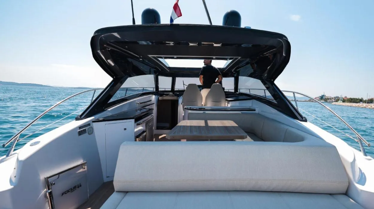 Luxurious 2026 Focus Power 44 yacht interior with seating, ocean view, and modern design.
