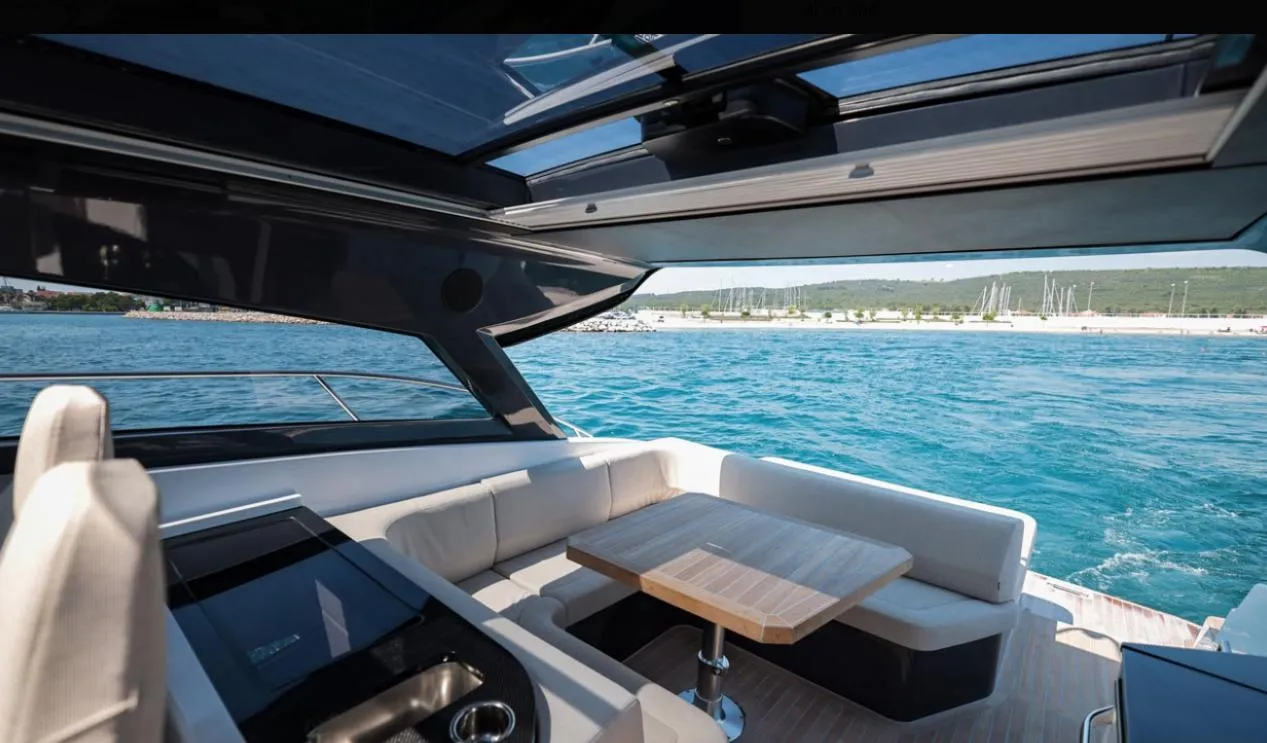 Luxurious 2026 Focus Power 44 yacht interior with ocean view and elegant seating area.