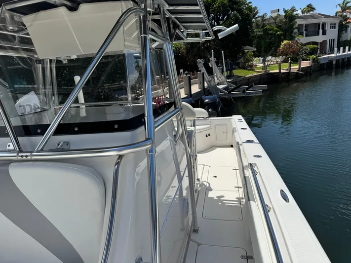  Yacht Photos Pics 2008 Fountain 34 Center Console boat docked by a canal, showcasing sleek design.