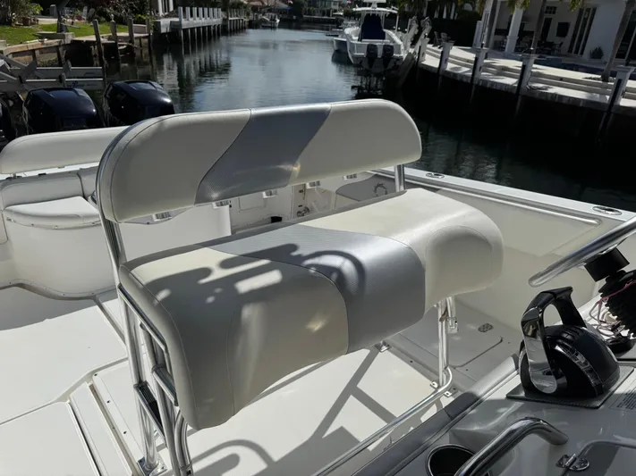  Yacht Photos Pics 2008 Fountain 34 Center Console boat with cushioned seating, docked by a canal.