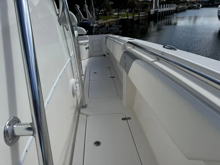  Yacht Photos Pics 2008 Fountain 34 Center Console boat deck, sleek design, docked by calm water.