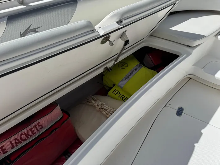  Yacht Photos Pics Storage compartment of 2008 Fountain 34 Center Console with life jackets and safety gear.
