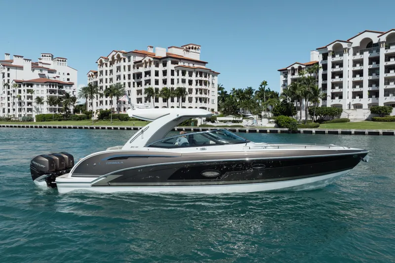 Knot Again Yacht Photos Pics 2018 Formula 350 Crossover Bowrider OB cruising near luxury waterfront buildings.