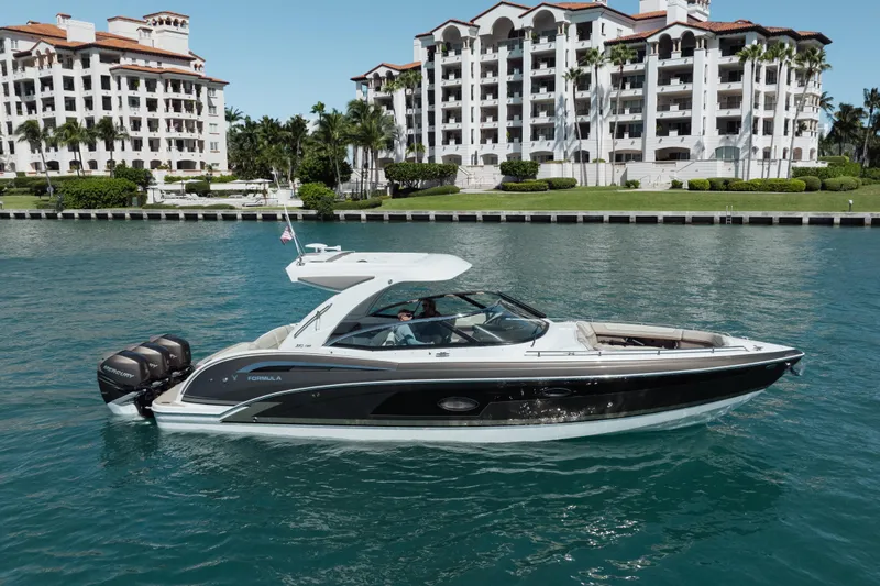 Knot Again Yacht Photos Pics 2018 Formula 350 Crossover Bowrider OB cruising near luxury waterfront residences.