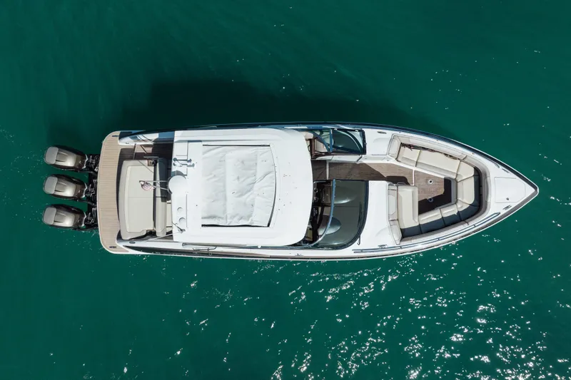 Knot Again Yacht Photos Pics Aerial view of 2018 Formula 350 Crossover Bowrider OB on turquoise water.