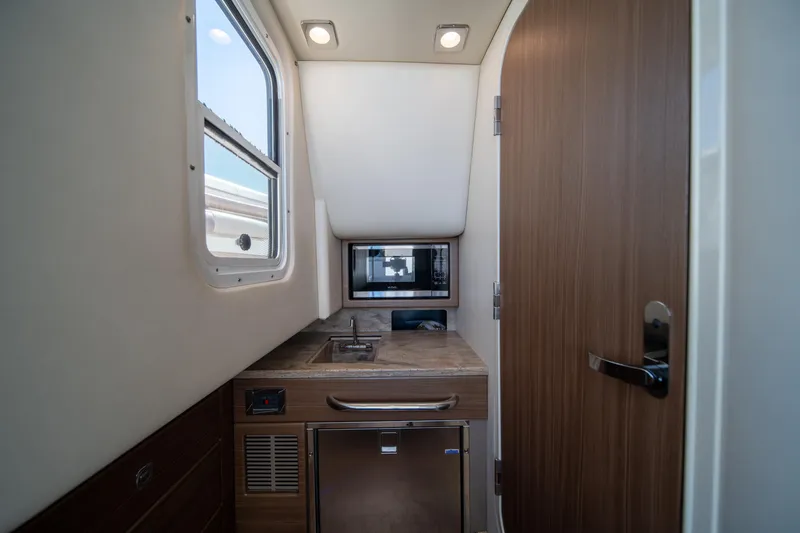 Knot Again Yacht Photos Pics Interior of 2018 Formula 350 Crossover Bowrider OB, featuring kitchenette with sink and microwave.
