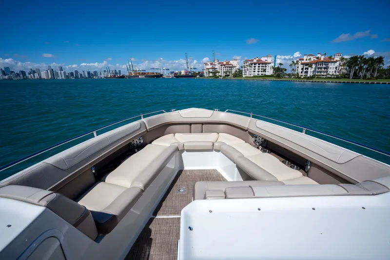 Knot Again Yacht Photos Pics 2018 Formula 350 Crossover Bowrider OB on water, city skyline in background.