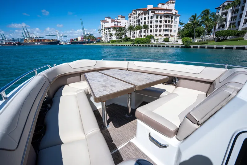 Knot Again Yacht Photos Pics 2018 Formula 350 Crossover Bowrider OB with luxurious seating, docked near waterfront buildings.