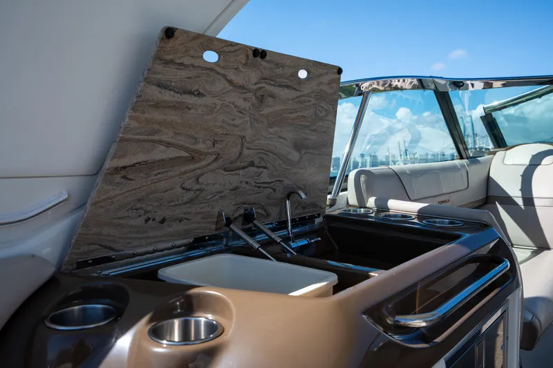 Knot Again Yacht Photos Pics 2018 Formula 350 Crossover Bowrider OB interior with sink and seating area.
