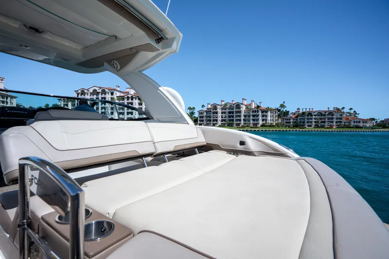 Knot Again Yacht Photos Pics 2018 Formula 350 Crossover Bowrider OB on water, luxury seating, coastal buildings in background.