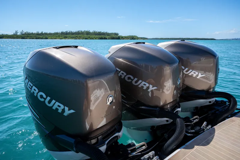 Knot Again Yacht Photos Pics Triple Mercury outboard engines on a 2018 Formula 350 Crossover Bowrider OB in clear blue waters.