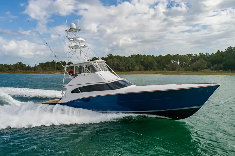 Safari Yacht Photos Pics 1997 Garlington 61 yacht cruising on water, showcasing sleek design and powerful performance.