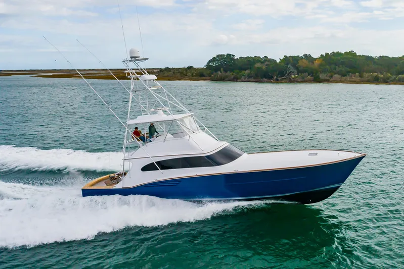 Safari Yacht Photos Pics 1997 Garlington 61 yacht cruising on open water, showcasing sleek design and powerful performance.