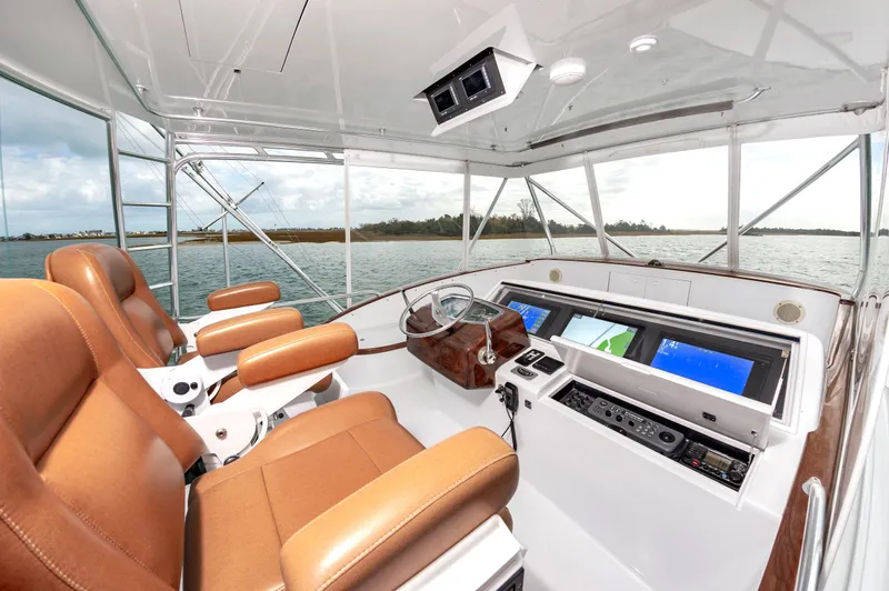 Safari Yacht Photos Pics Luxurious 1997 Garlington 61 yacht helm with leather seats and advanced navigation systems.