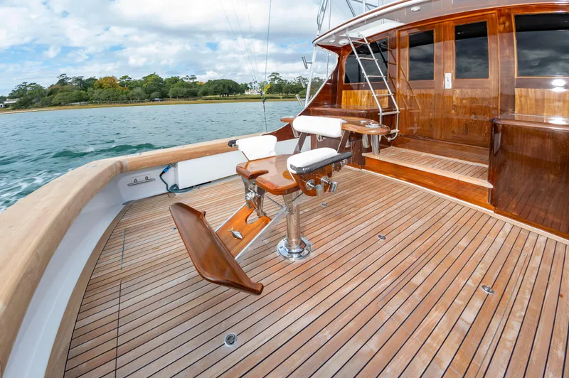 Safari Yacht Photos Pics Luxurious 1997 Garlington 61 yacht deck with wooden flooring and fishing chair.