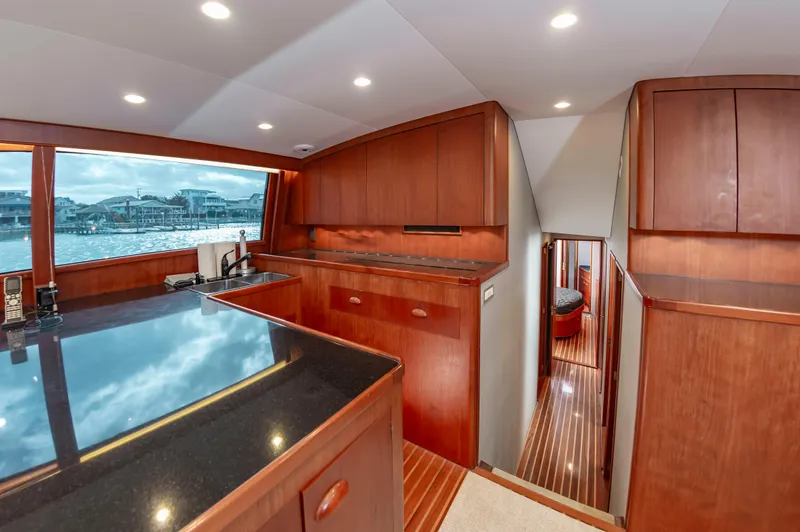 Safari Yacht Photos Pics Luxurious interior of a 1997 Garlington 61 yacht with wood cabinetry and ocean view.