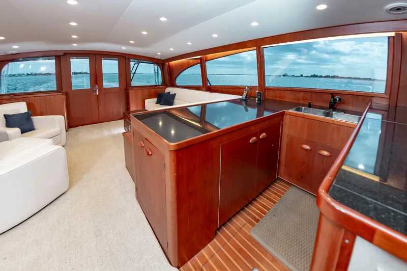 Safari Yacht Photos Pics Luxurious 1997 Garlington 61 yacht interior with wood finishes and ocean view.