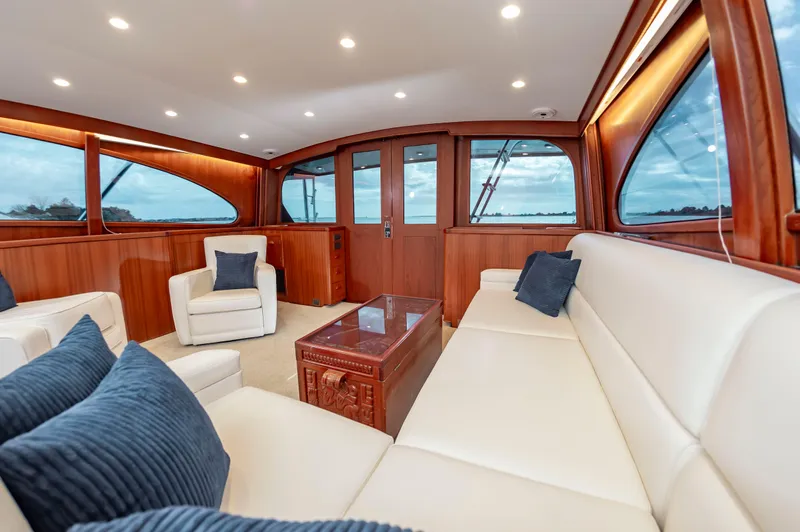 Safari Yacht Photos Pics Luxurious interior of 1997 Garlington 61 yacht with plush seating and wooden accents.