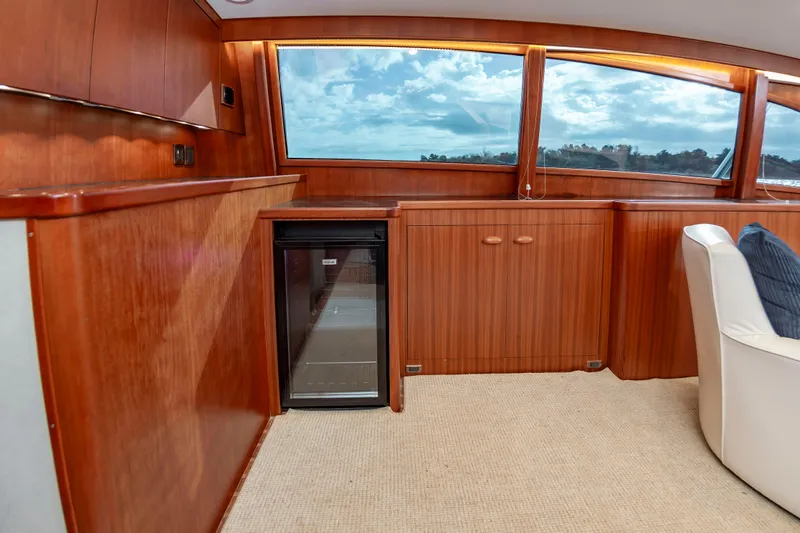 Safari Yacht Photos Pics Luxurious 1997 Garlington 61 yacht interior with wood paneling and mini fridge.