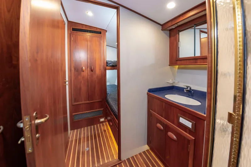 Safari Yacht Photos Pics Luxurious wooden interior of 1997 Garlington 61 yacht with bathroom and bunk beds.