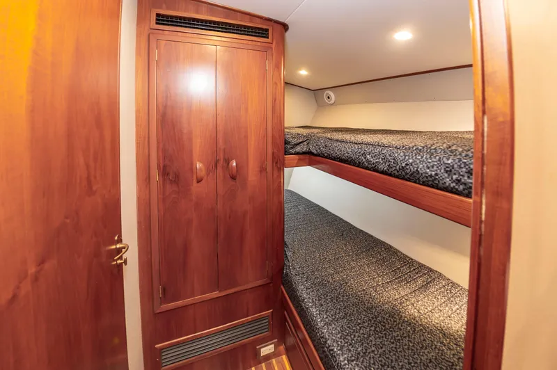 Safari Yacht Photos Pics Interior of 1997 Garlington 61 yacht with wooden bunk beds and closet.