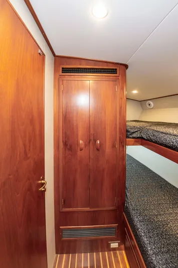 Safari Yacht Photos Pics Interior of 1997 Garlington 61 yacht with wooden cabinetry and bunk beds.