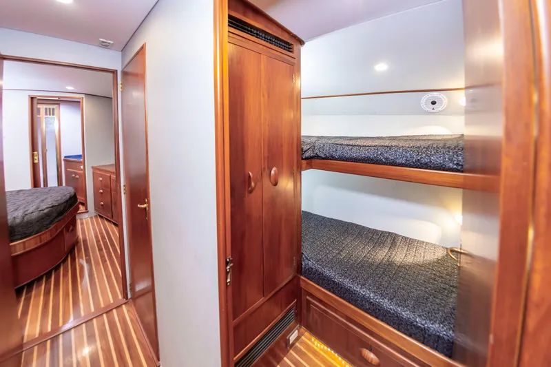 Safari Yacht Photos Pics Interior of 1997 Garlington 61 yacht with wooden bunk beds and polished flooring.