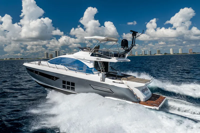  Yacht Photos Pics 2021 Azimut S6 Sportfly yacht cruising on open water under a clear blue sky.