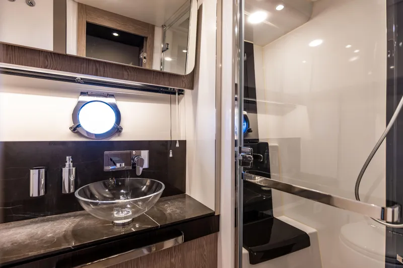  Yacht Photos Pics Luxurious bathroom in 2021 Azimut S6 Sportfly yacht with glass sink and modern fixtures.