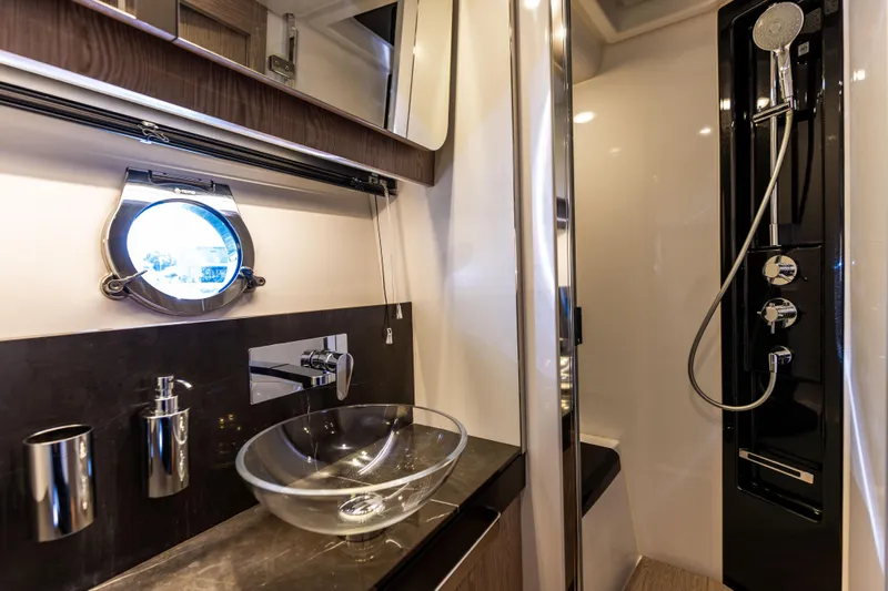  Yacht Photos Pics Luxurious bathroom in 2021 Azimut S6 Sportfly yacht with modern fixtures and glass sink.