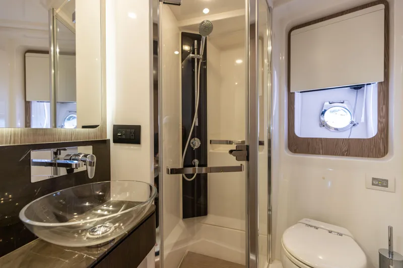  Yacht Photos Pics Luxurious bathroom in 2021 Azimut S6 Sportfly yacht with modern fixtures and glass sink.