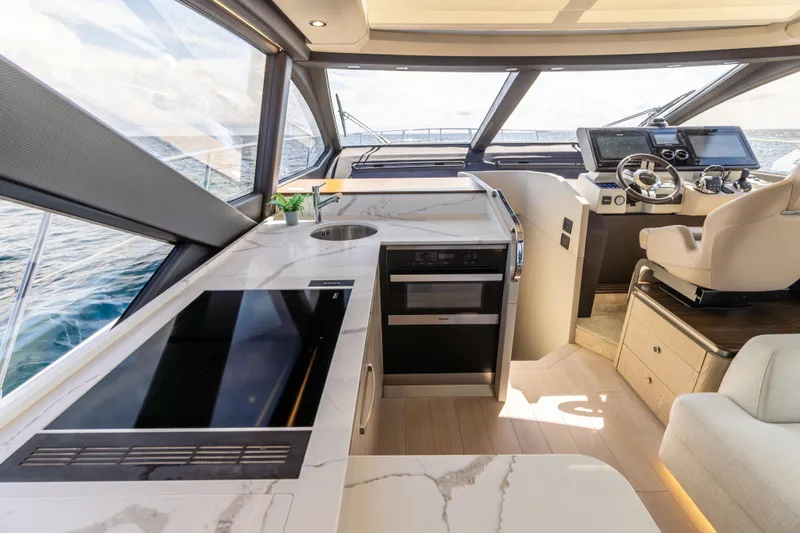  Yacht Photos Pics Luxurious interior of 2021 Azimut S6 Sportfly yacht with modern kitchen and helm.