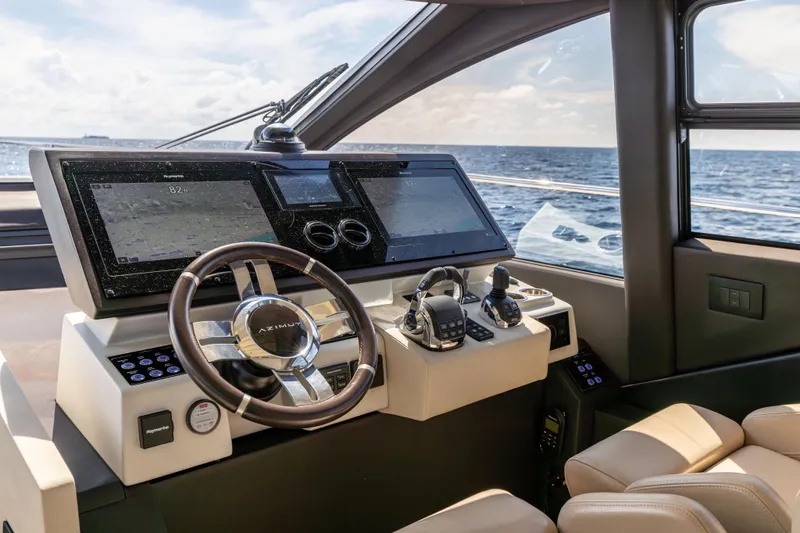  Yacht Photos Pics 2021 Azimut S6 Sportfly helm with advanced navigation systems and luxurious seating, overlooking the ocean.
