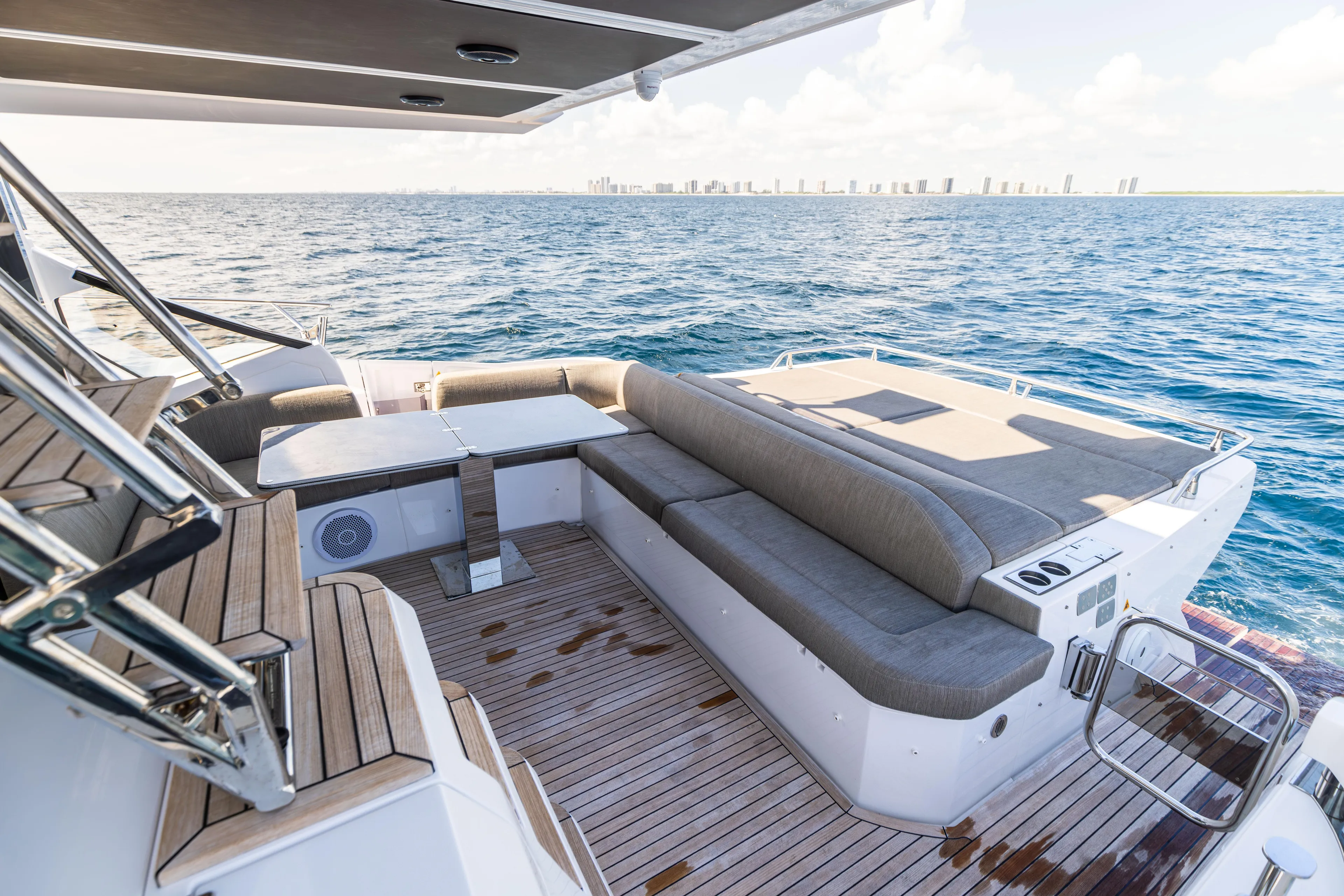  Yacht Photos Pics Luxurious 2021 Azimut S6 Sportfly yacht deck with seating, overlooking ocean and city skyline.