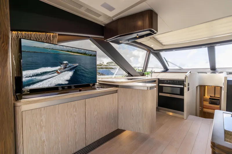  Yacht Photos Pics Luxurious interior of 2021 Azimut S6 Sportfly yacht with modern kitchen and large TV display.