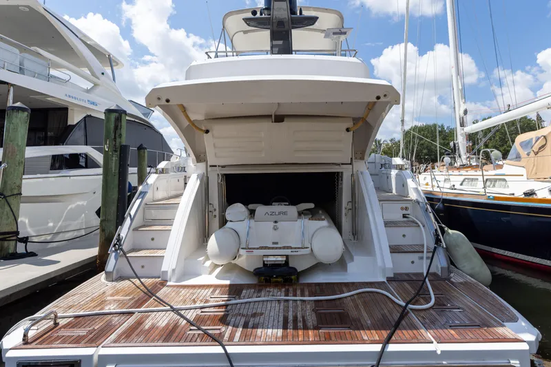  Yacht Photos Pics 2021 Azimut S6 Sportfly yacht docked, showcasing rear deck and open storage compartment.
